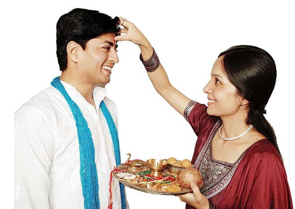 Applying Tilak, Chawal on Forehead