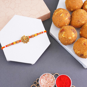 Ganesha Golden Rakhi with Haldiram Besan Laddu - Rakhi with Sweets