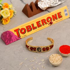 Om And Rudraksha Bracelet Rakhi With Toblerone Chocolate - Kids Rakhi to UAE